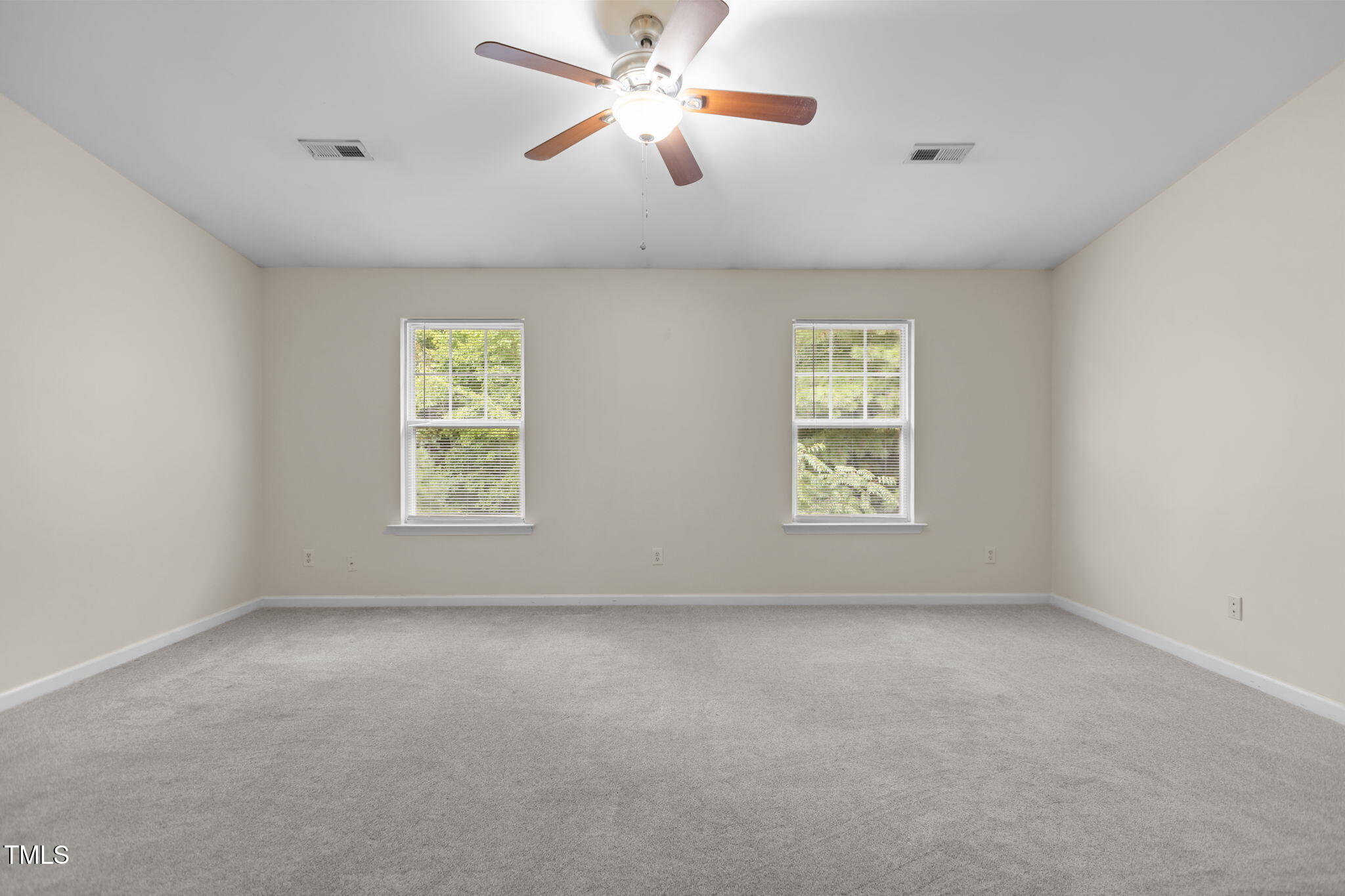 11720 Mezzanine Drive, Unit 103 Raleigh, NC 27614 - Photo 13 of 18 an empty room with windows and fan
