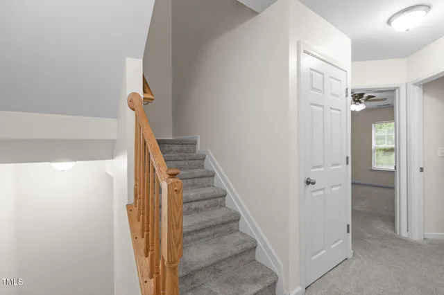 a view of a hallway with wooden floor and entryway