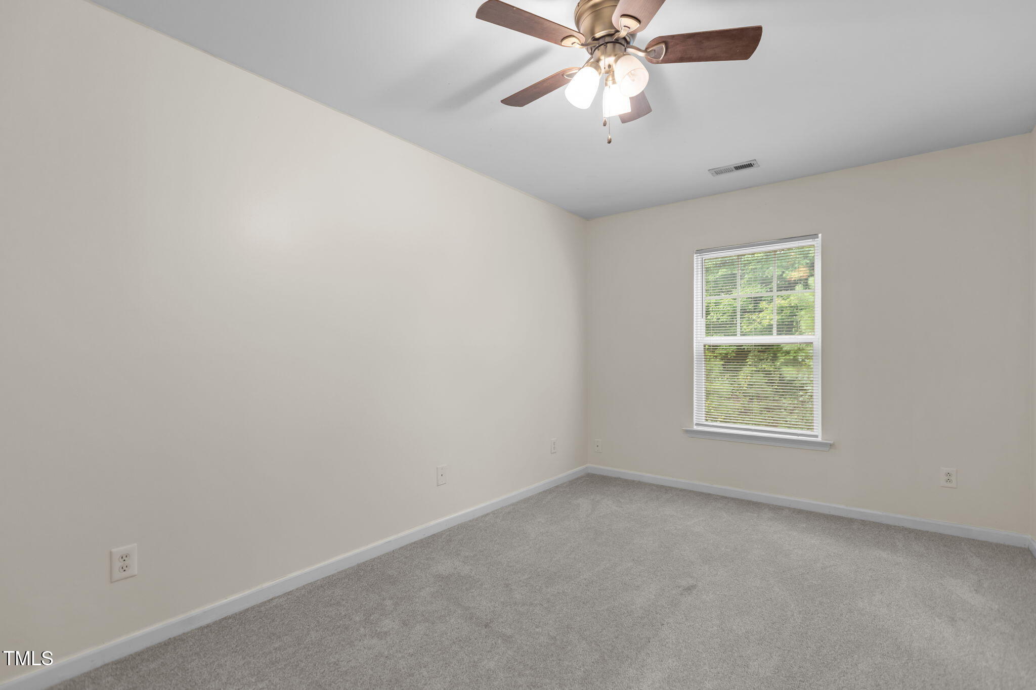 11720 Mezzanine Drive, Unit 103 Raleigh, NC 27614 - Photo 8 of 18 an empty room with a window and a fan