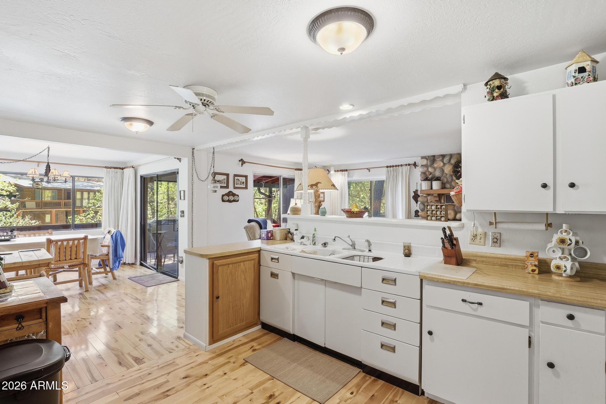 250 East Saddle Mountain Road Payson, AZ 85541 - Photo 12 of 32 a kitchen with a sink stove and cabinets