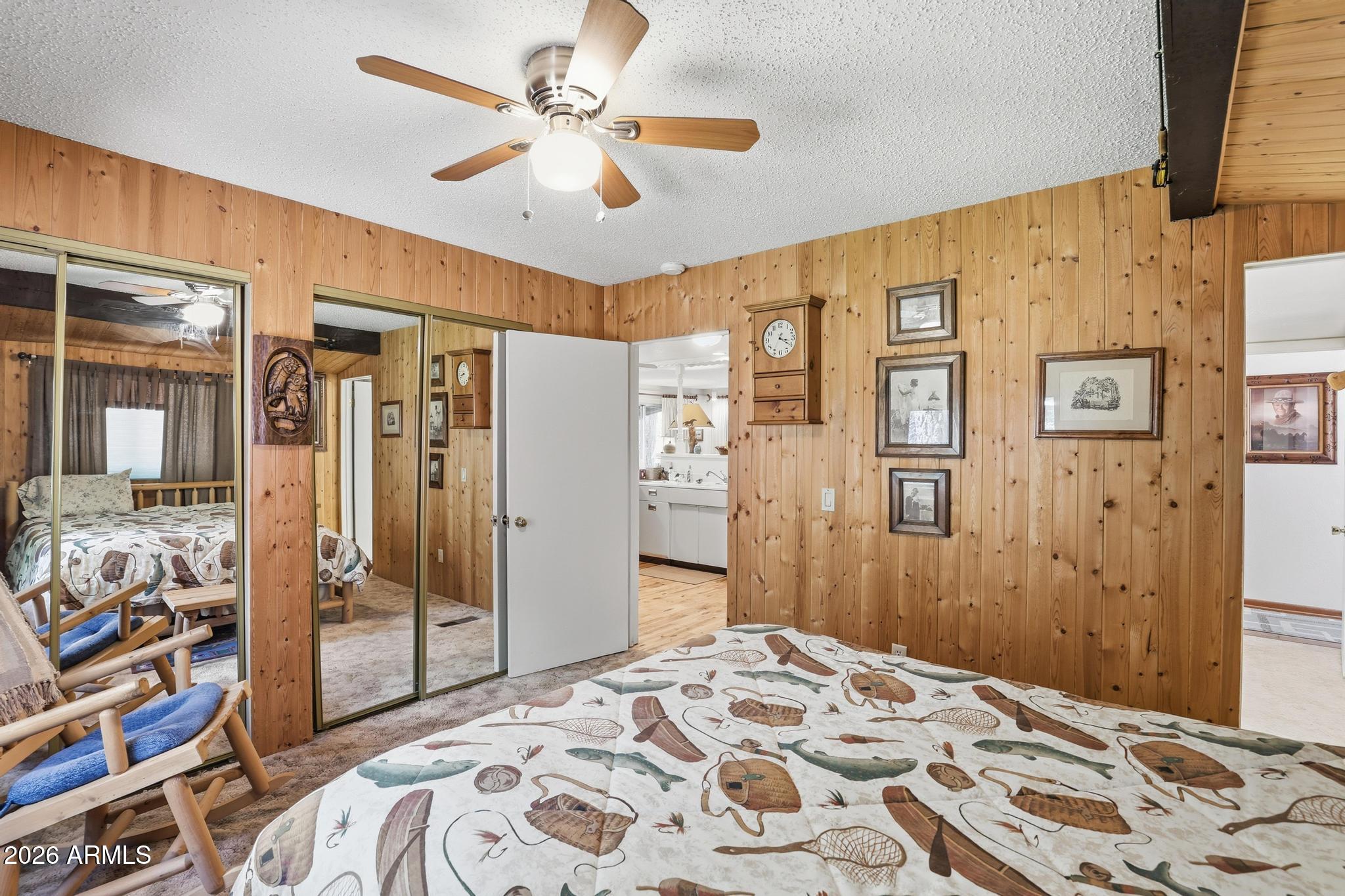 250 East Saddle Mountain Road Payson, AZ 85541 - Photo 14 of 32 a bedroom with a bed and a chandelier
