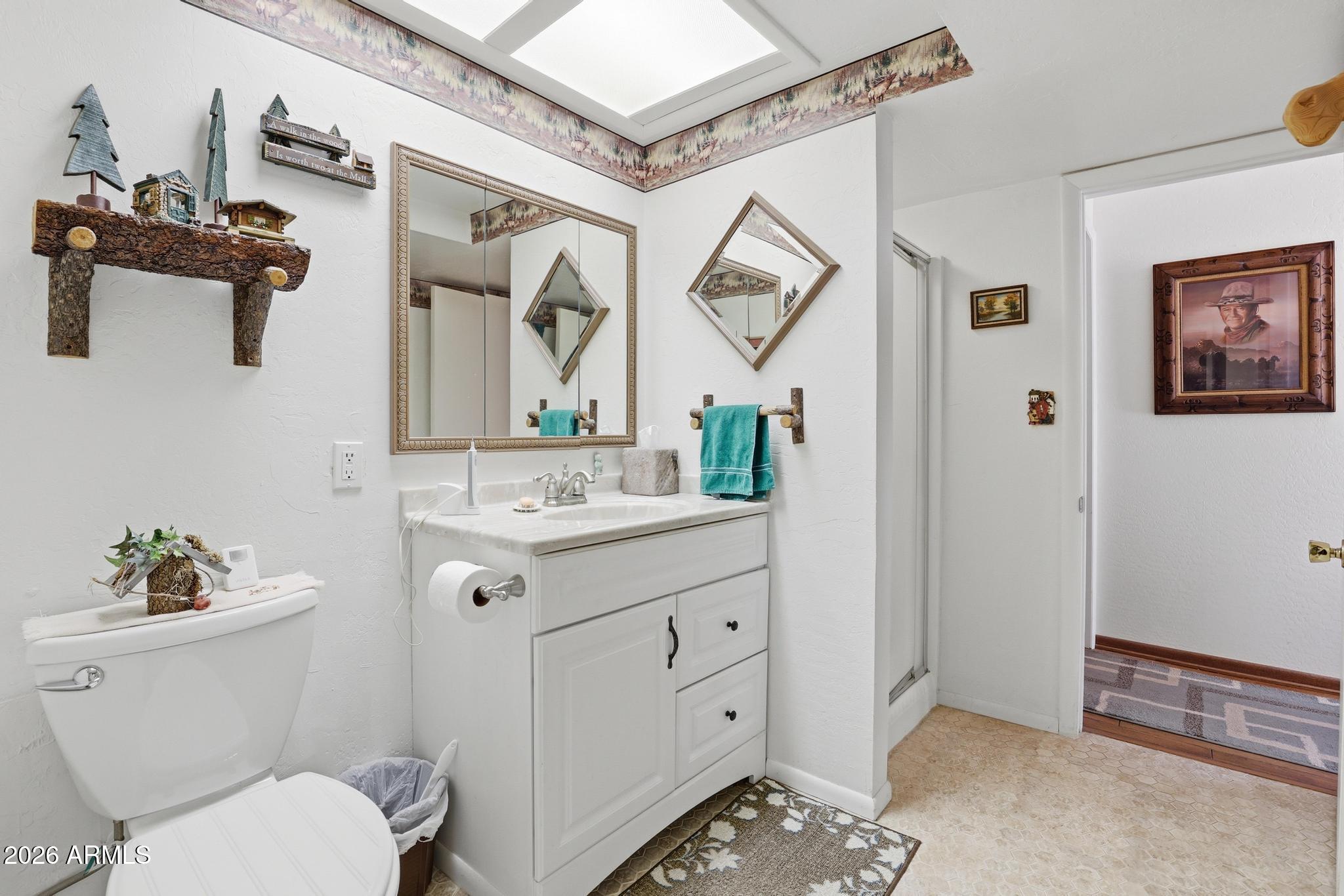 250 East Saddle Mountain Road Payson, AZ 85541 - Photo 15 of 32 a bathroom with a toilet sink and mirror