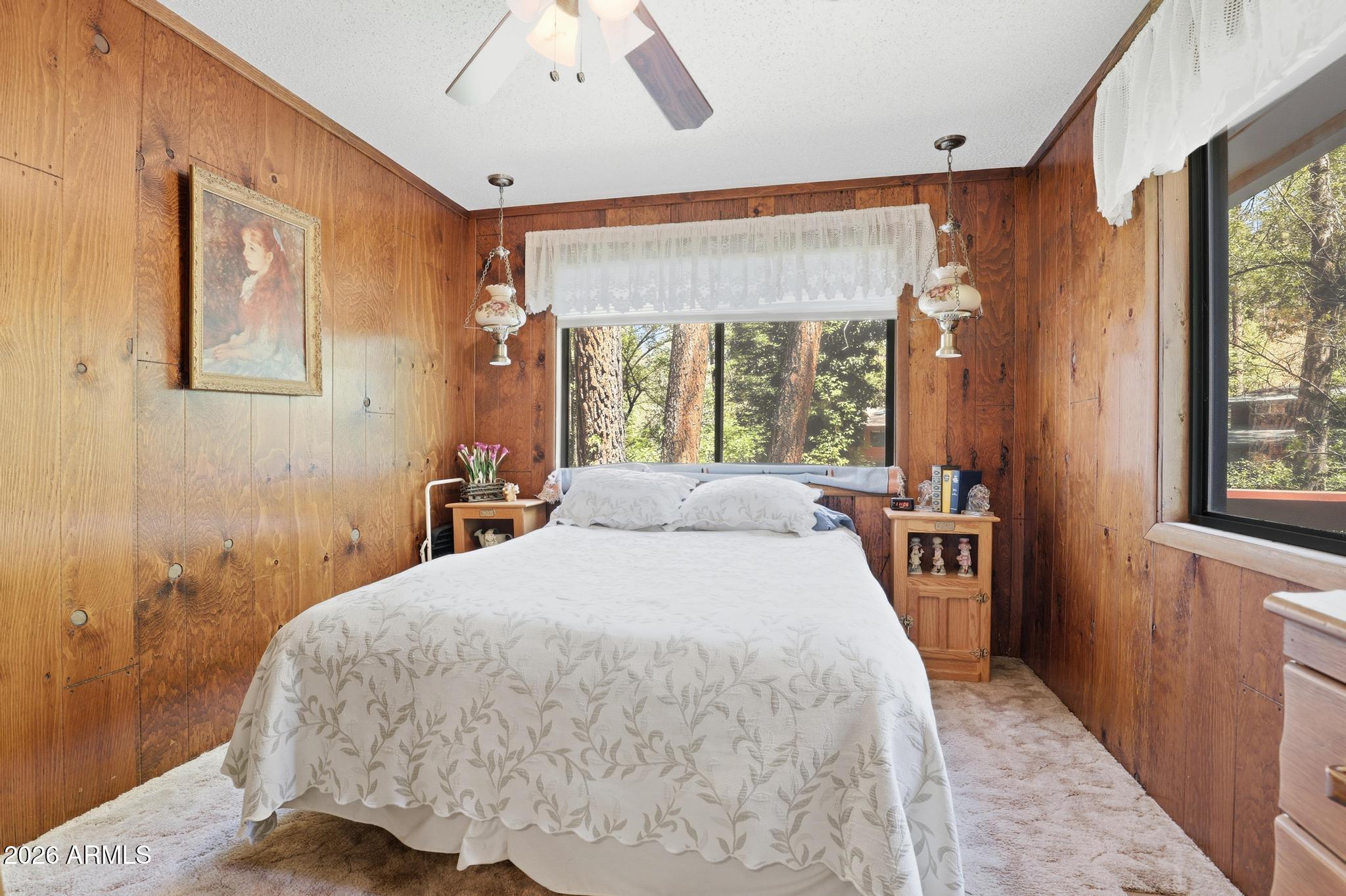 250 East Saddle Mountain Road Payson, AZ 85541 - Photo 18 of 32 a bedroom with a large bed and a large window