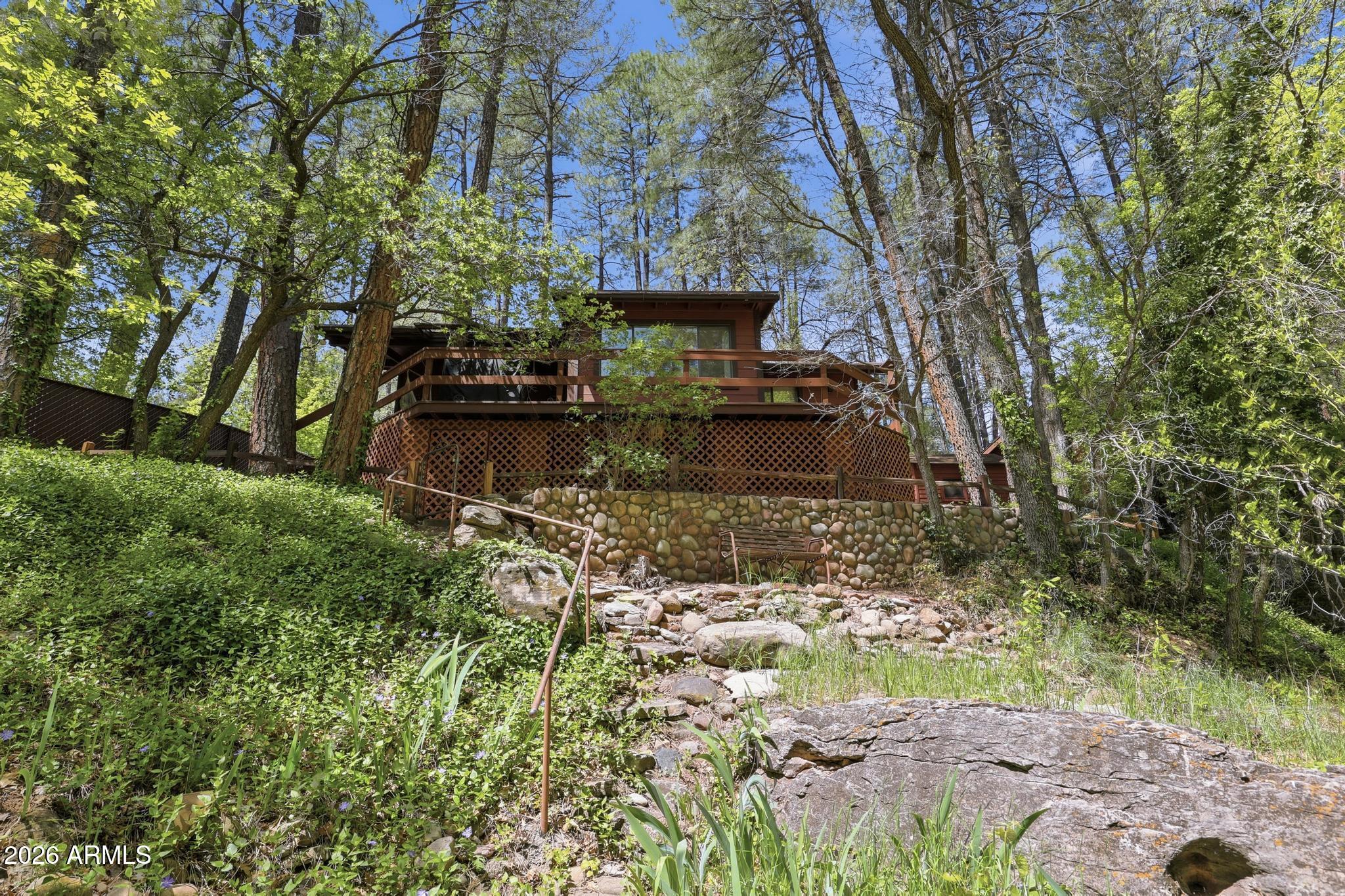 250 East Saddle Mountain Road Payson, AZ 85541 - Photo 25 of 32 a view of a water fountain with large trees