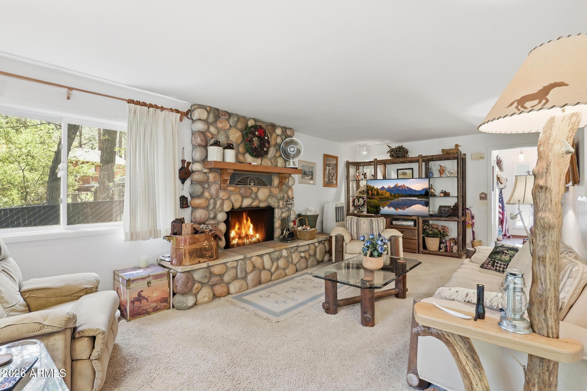 250 East Saddle Mountain Road Payson, AZ 85541 - Photo 5 of 32 a living room with furniture and a fireplace