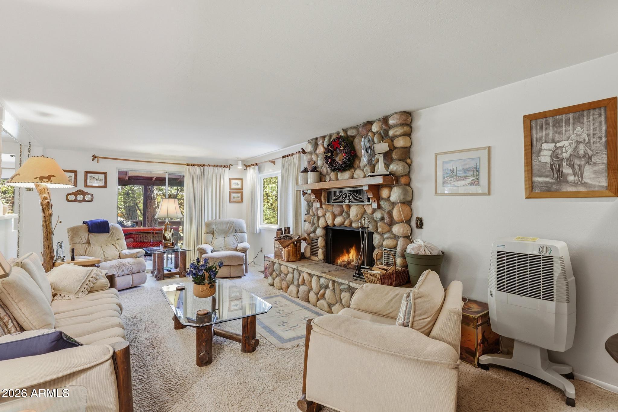 250 East Saddle Mountain Road Payson, AZ 85541 - Photo 6 of 32 a living room with furniture and a fireplace
