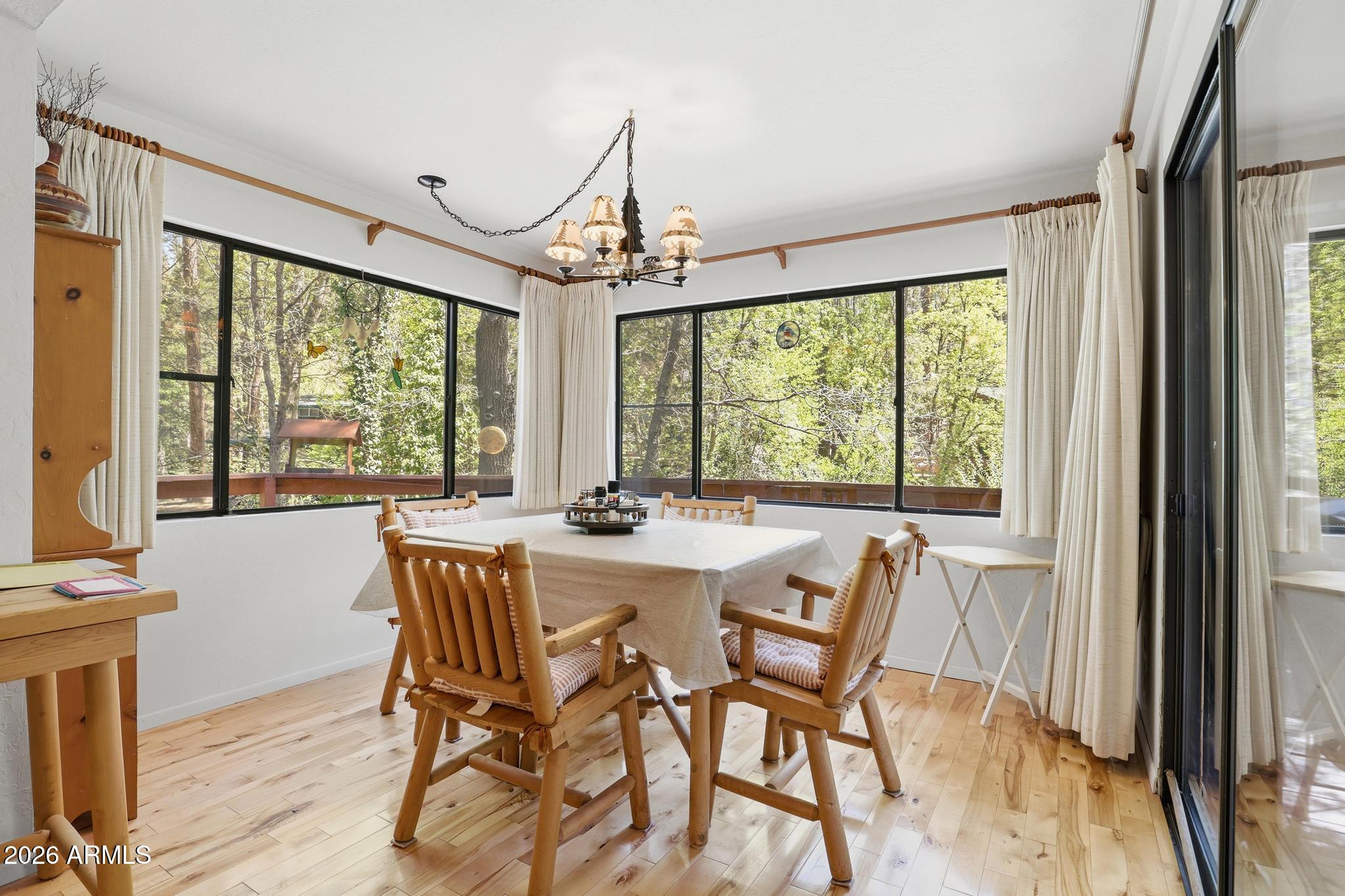 250 East Saddle Mountain Road Payson, AZ 85541 - Photo 10 of 32 a view of a dining room with furniture large windows and wooden floor