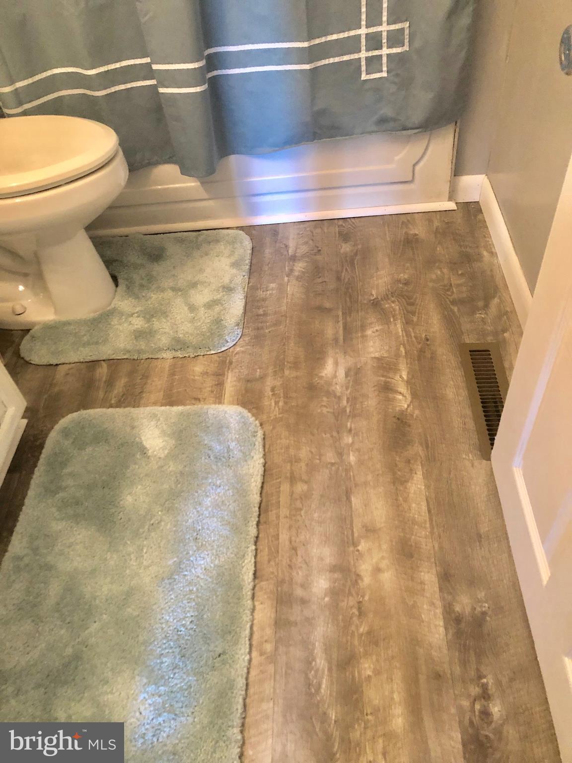 2703 West Woodwell Road Baltimore, MD 21222 - Photo 32 of 67 BATHROOM HAS NEW GRAY LAMINATE FLOORING