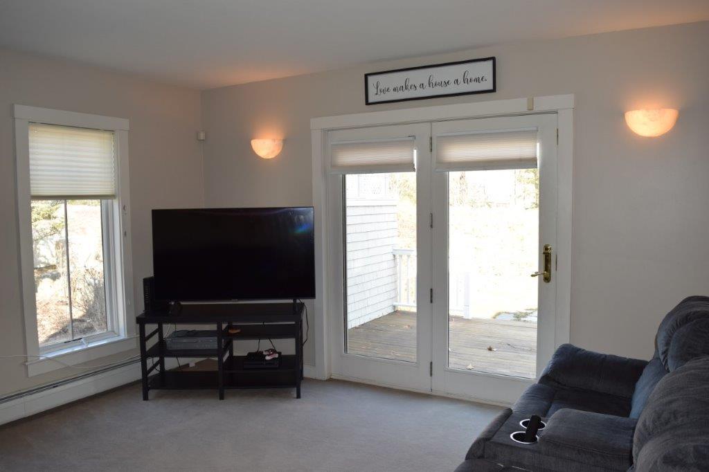 28 Springbrook Drive, Unit 28A Belfast, ME 04915 - Photo 12 of 20 living room off large sunny deck.