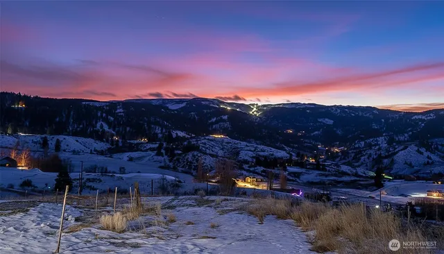a view of a patio with a table and chairs under an umbrella