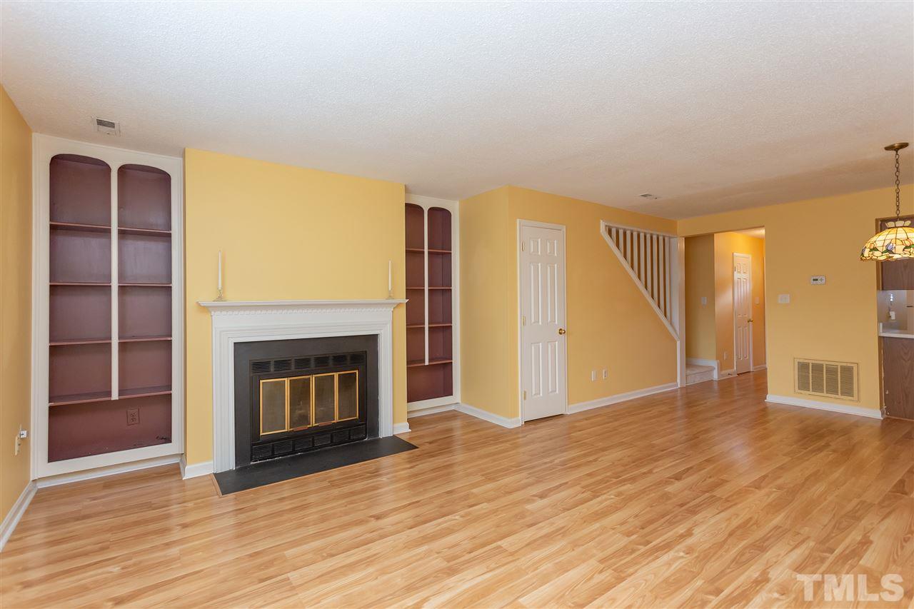 3314 Comstock Road Raleigh, NC 27604 - Photo 8 of 28 a view of an empty room with wooden floor fireplace and a window