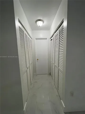 an empty room with a empty space and windows