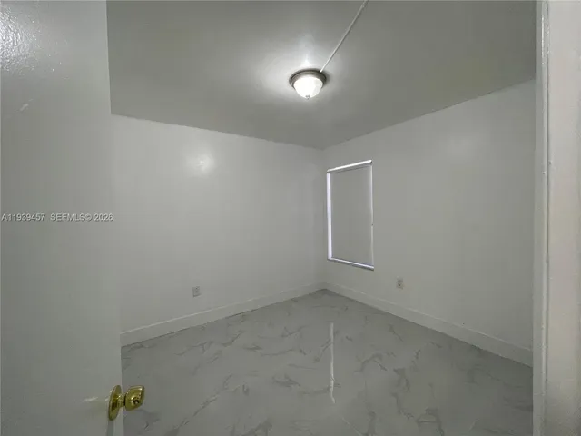 a white toilet sitting next to a shower curtain