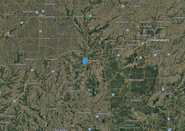 a bathroom with a shower and a tiled wall