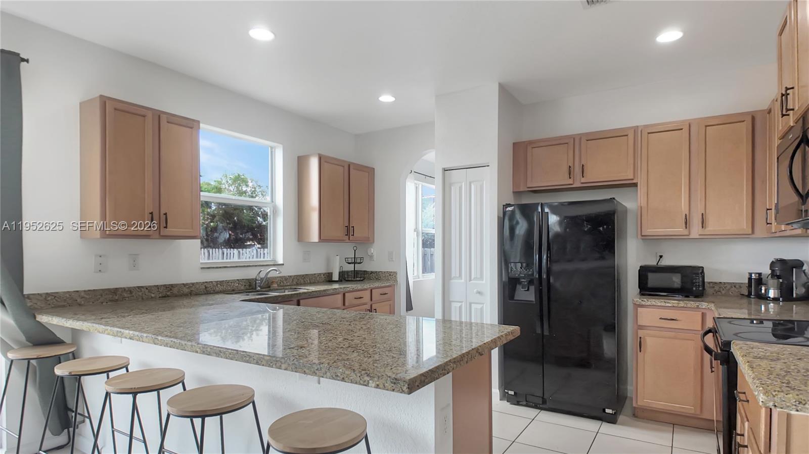 13160 Southwest 280th Street Homestead, FL 33033 - Photo 12 of 44 a kitchen with stainless steel appliances granite countertop a refrigerator a stove a sink a dining table and chairs