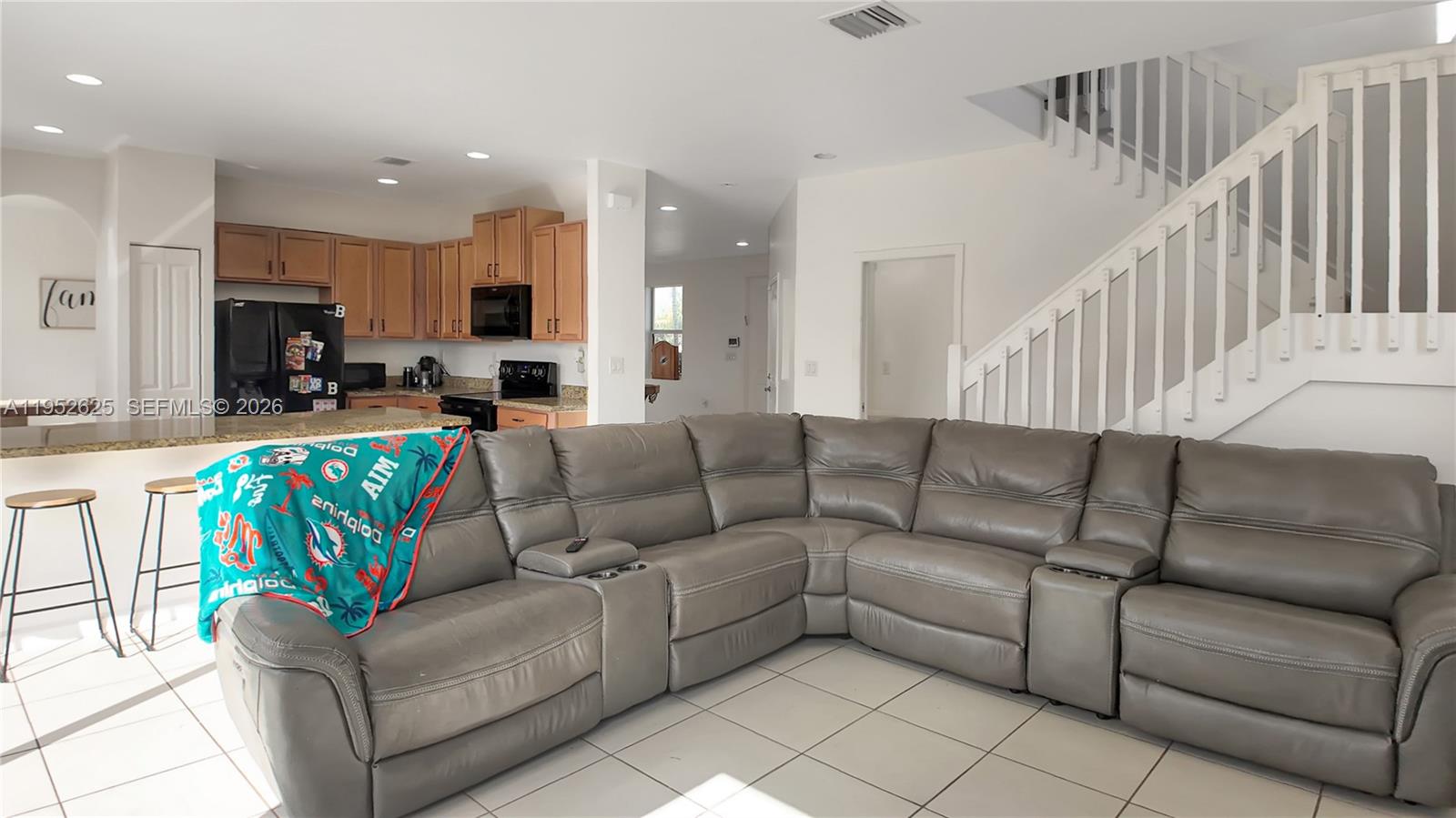 13160 Southwest 280th Street Homestead, FL 33033 - Photo 15 of 44 a living room with furniture kitchen view and a chandelier