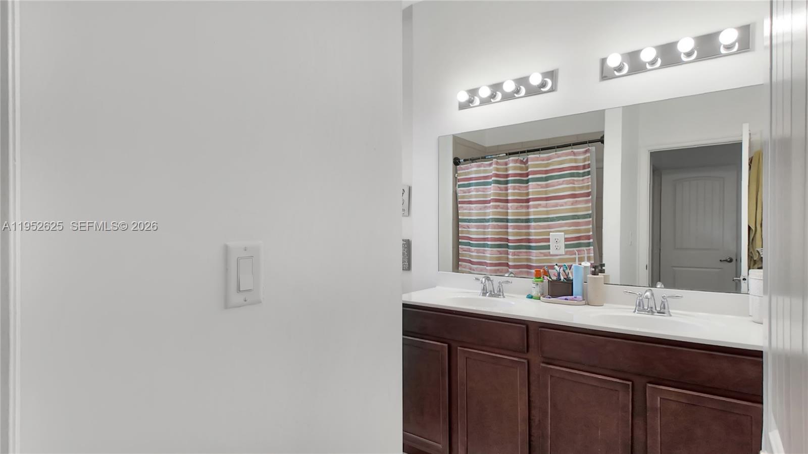 13160 Southwest 280th Street Homestead, FL 33033 - Photo 29 of 44 a bathroom with a sink and a mirror