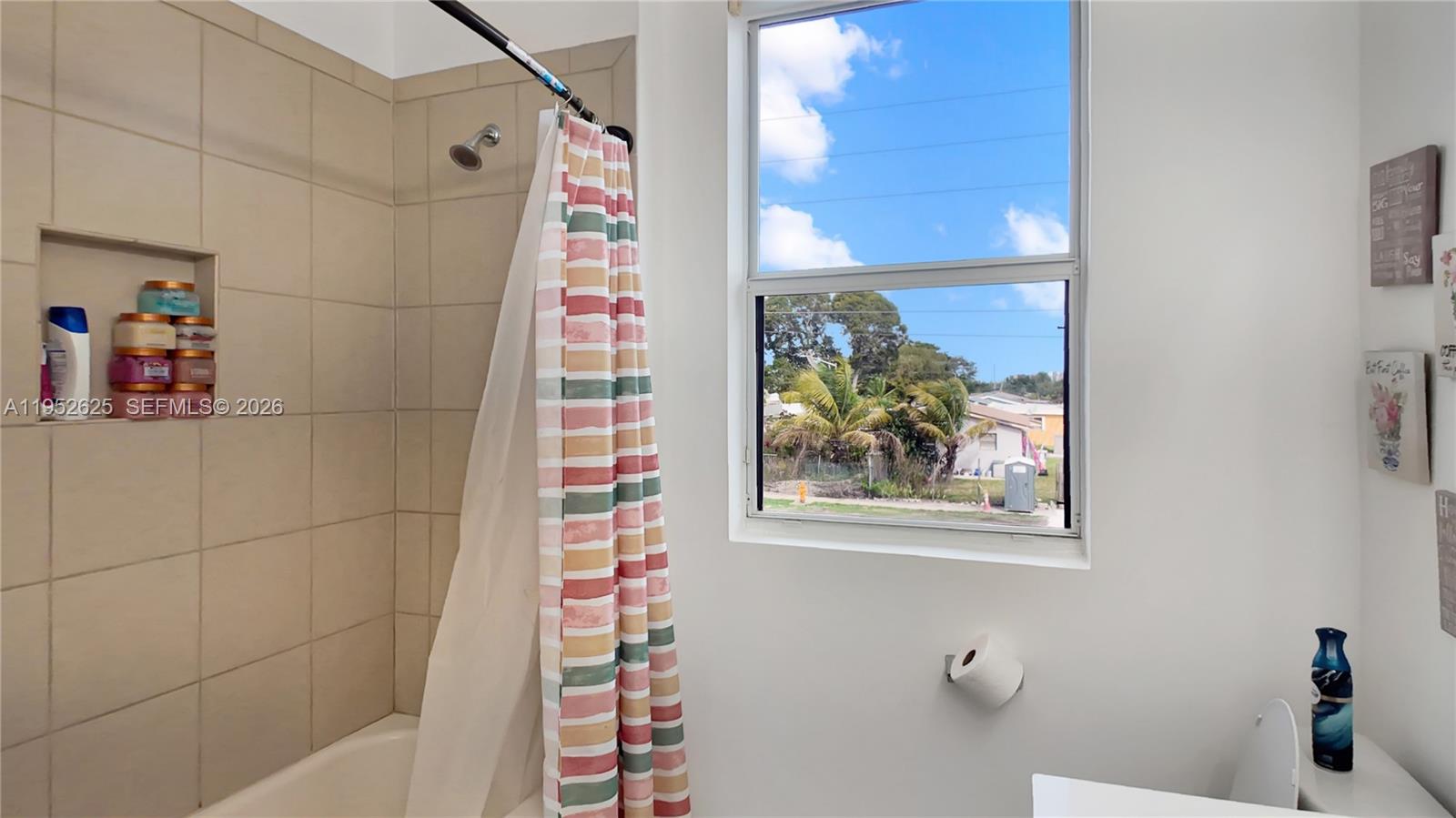 13160 Southwest 280th Street Homestead, FL 33033 - Photo 30 of 44 a bathroom with a window and a shower
