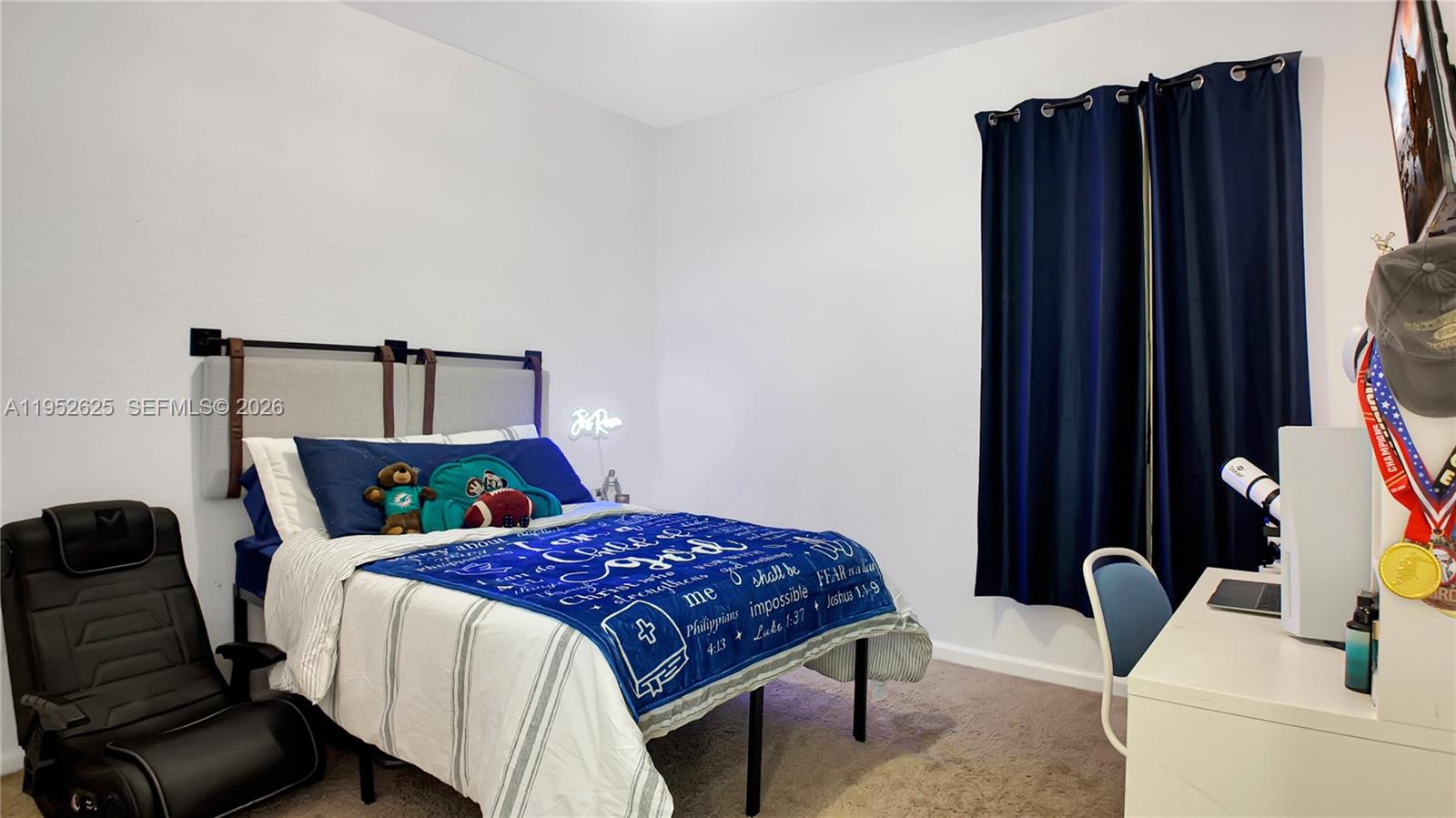 13160 Southwest 280th Street Homestead, FL 33033 - Photo 32 of 44 a bedroom with a bed and a flat tv screen