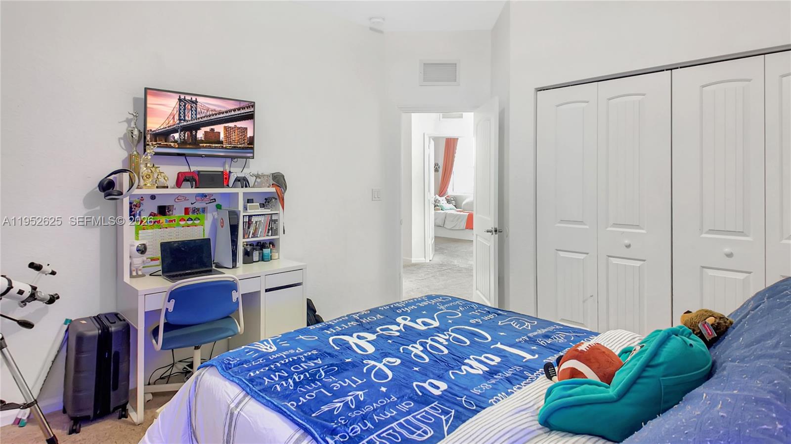 13160 Southwest 280th Street Homestead, FL 33033 - Photo 33 of 44 a bedroom with a bed a computer on desk and a lamp on desk