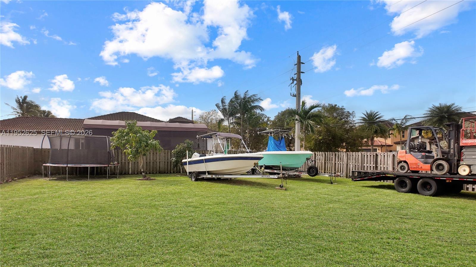 13160 Southwest 280th Street Homestead, FL 33033 - Photo 40 of 44 a car parked in front of a house with a yard