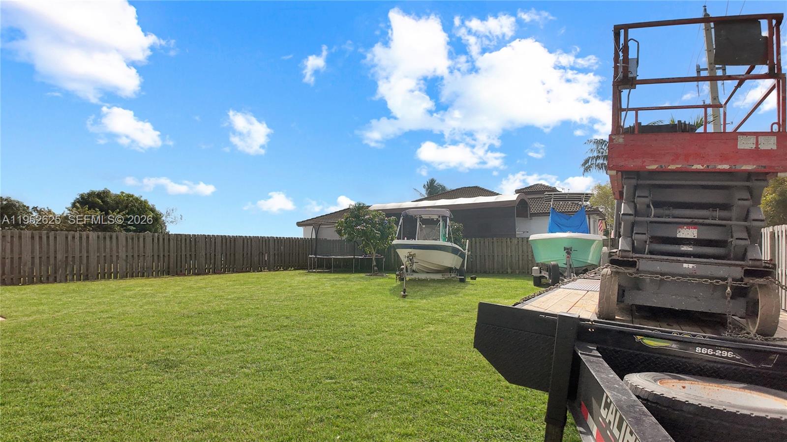 13160 Southwest 280th Street Homestead, FL 33033 - Photo 41 of 44 a backyard of a house with table and chairs