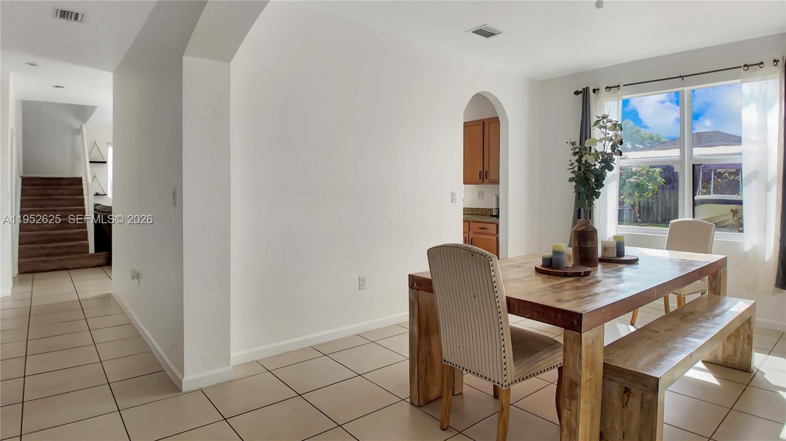 13160 Southwest 280th Street Homestead, FL 33033 - Photo 9 of 44 a view of a workspace with furniture and a window