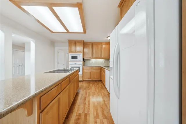 a bedroom with a bed and a couch with window