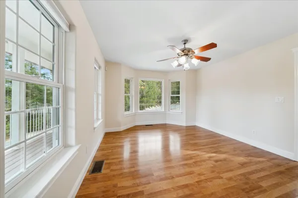 a view of entryway and hall with wooden floor