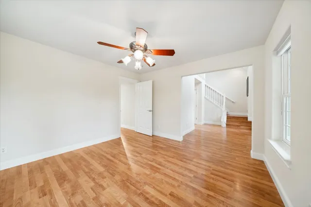 a view of staircase with white walls and a window