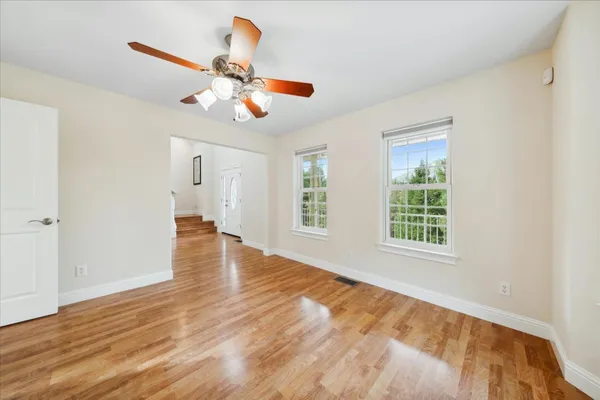 a view of entryway and hall with wooden floor