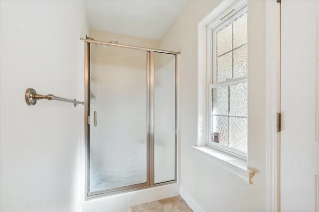 a view of a room with wooden floor and a ceiling fan