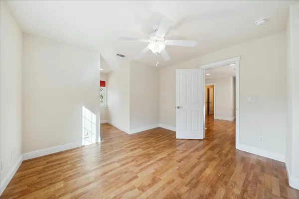 a view of staircase with white walls and white door