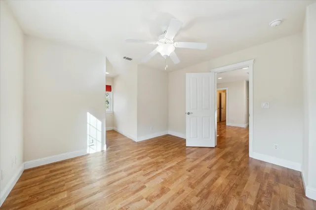 a view of staircase with white walls and white door