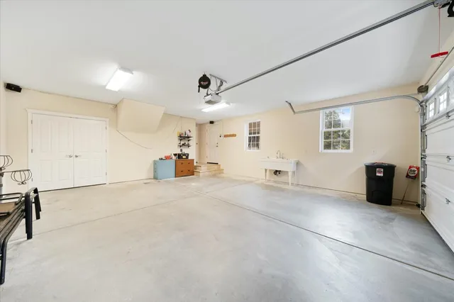 a view of a house with a garage and yard