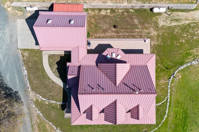 a front view of a house with a garden and deck