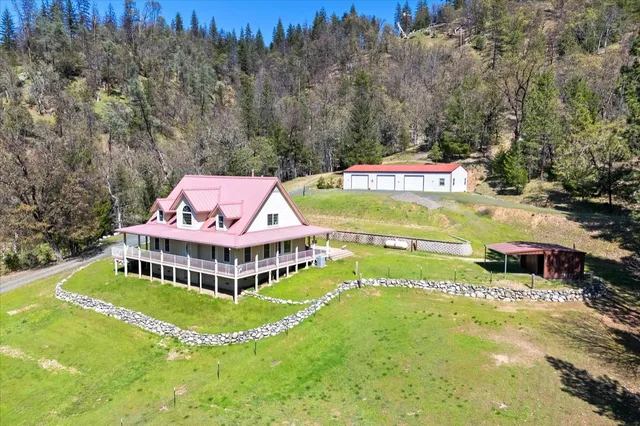 a backyard of a house with a yard and tree s
