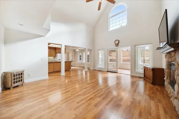 a kitchen with stainless steel appliances granite countertop a refrigerator a sink dishwasher and a stove with wooden floor