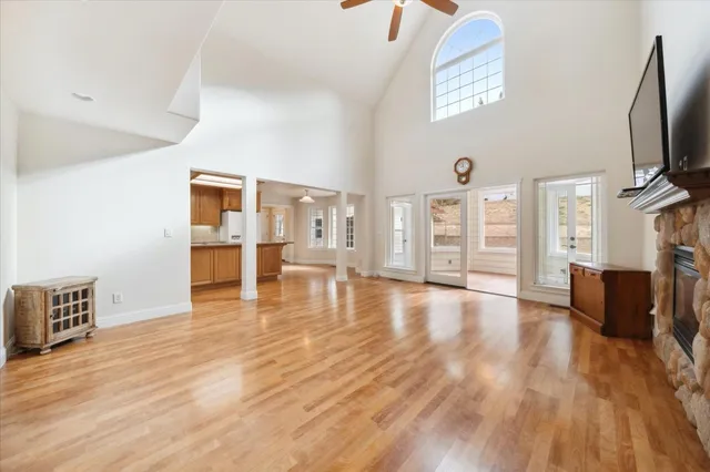 a kitchen with stainless steel appliances granite countertop a refrigerator a sink dishwasher and a stove with wooden floor