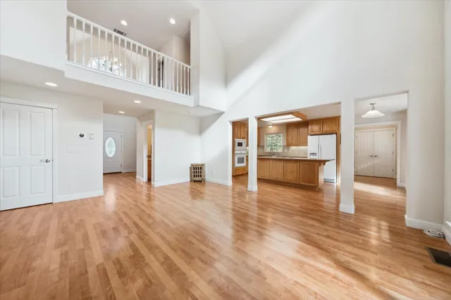 a kitchen with stainless steel appliances granite countertop a kitchen island a stove a sink and a microwave