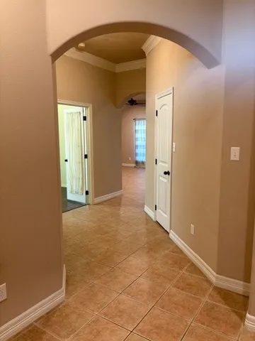 a view of a hallway with wooden shelves