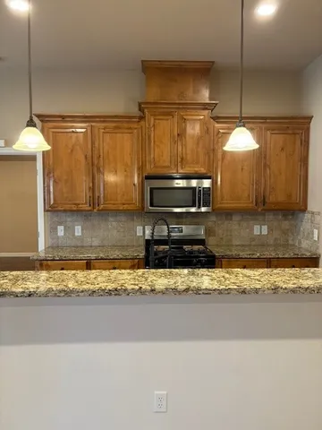 a kitchen with a stove a sink and a refrigerator