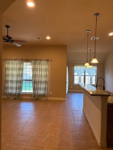 a view of a room with furniture and a floor to ceiling window