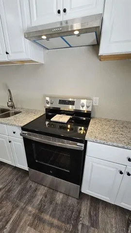 a stove top oven sitting inside of a kitchen