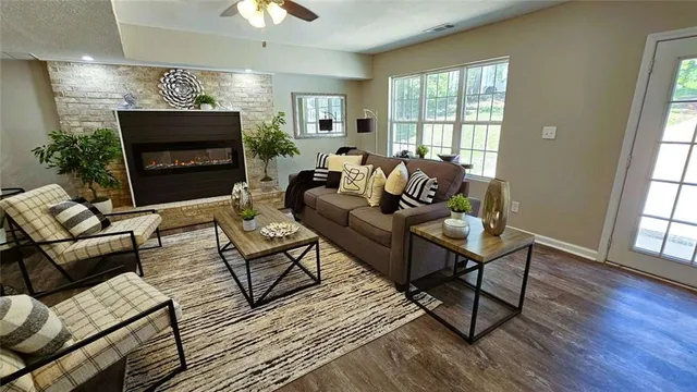 a living room with furniture a fireplace and a chandelier