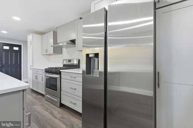 a kitchen with cabinets and stainless steel appliances
