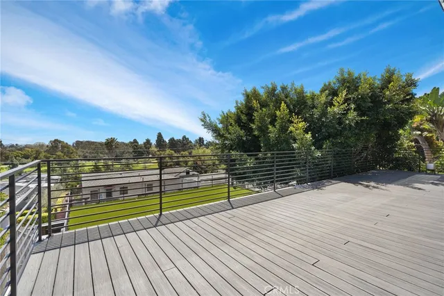 a view of a balcony with wooden floor and city view