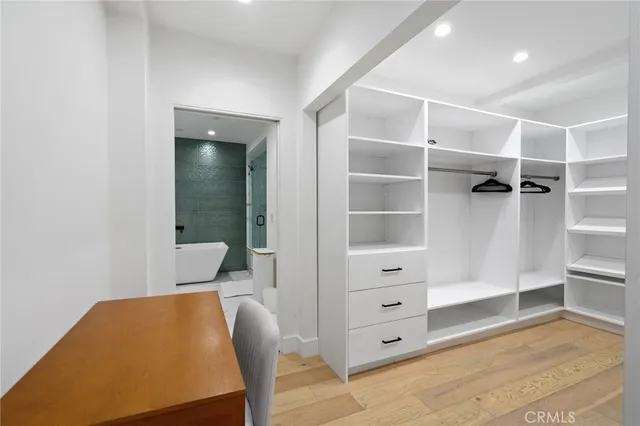 a view of walk in closet with empty racks