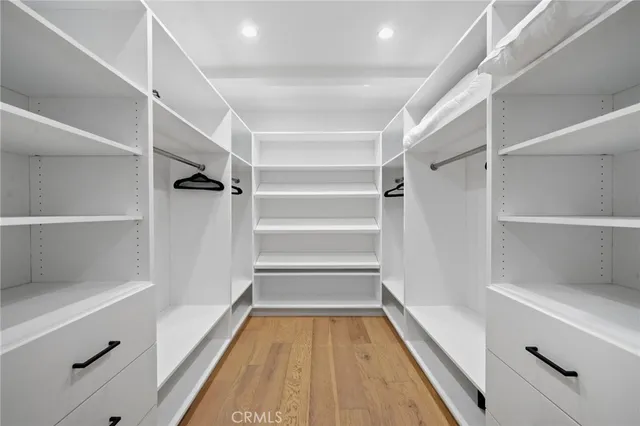 a bedroom with a bed and a large mirror