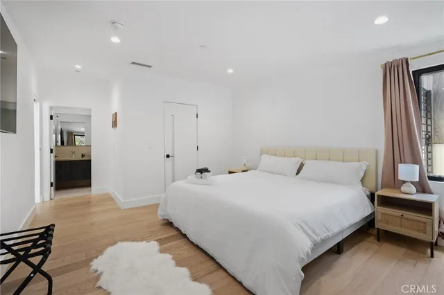 a bedroom with a bed and a flat screen tv